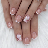 Floral Bliss short squoval press-on nails worn on a hand