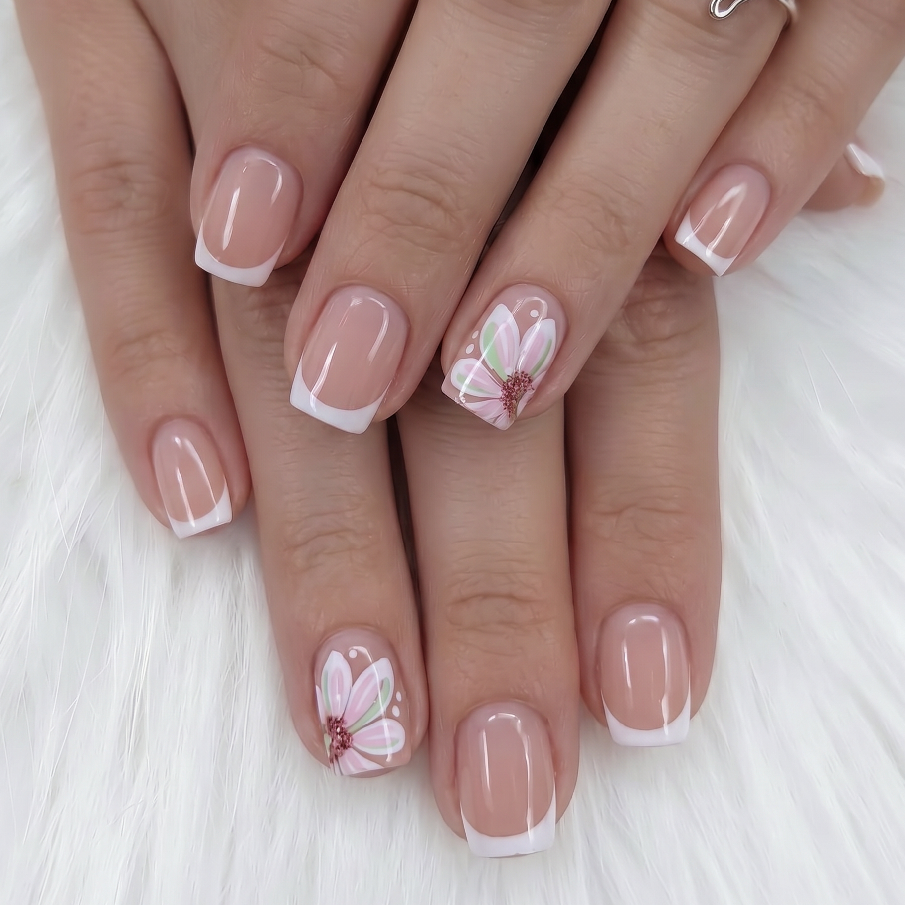 Floral Bliss short squoval press-on nails worn on a hand