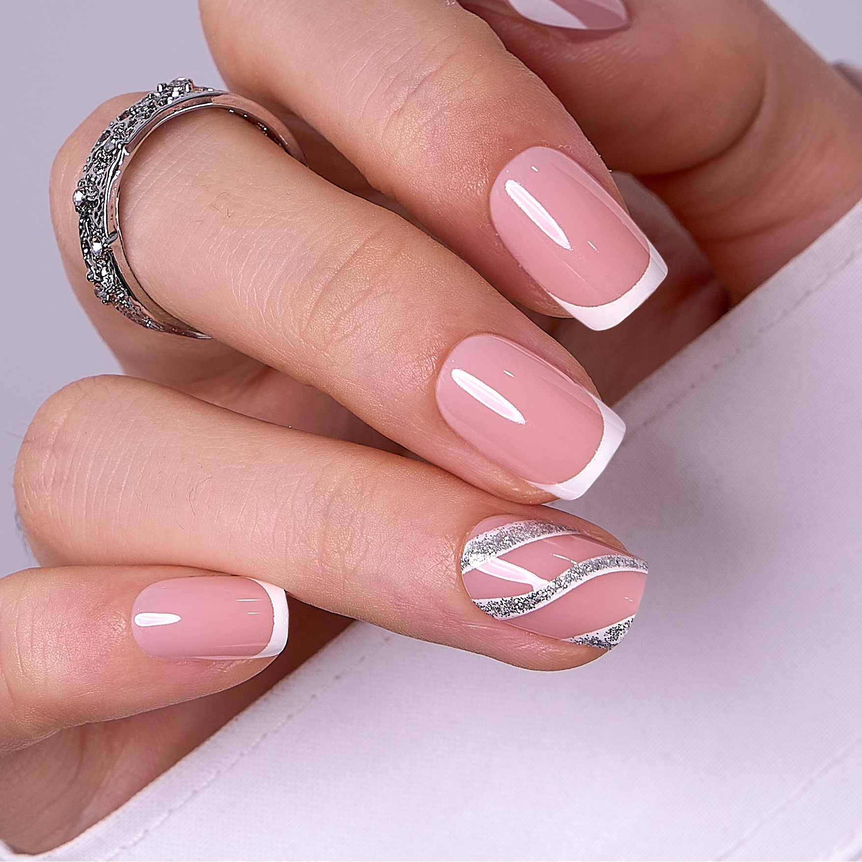French Spark short squoval press-on nails worn on a hand