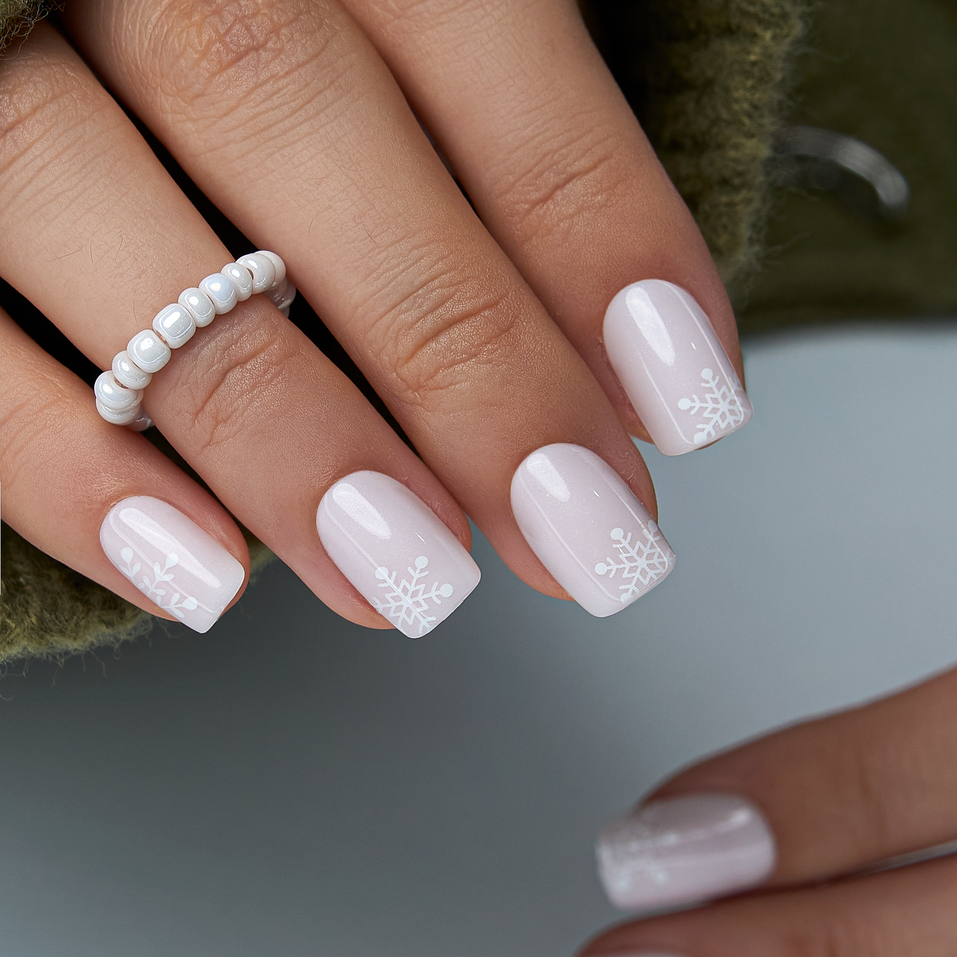 Frosty Whisper short squoval press-on nails worn on a hand