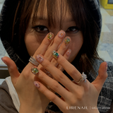 Galaxy Dream jeweled press-on nails worn by a model