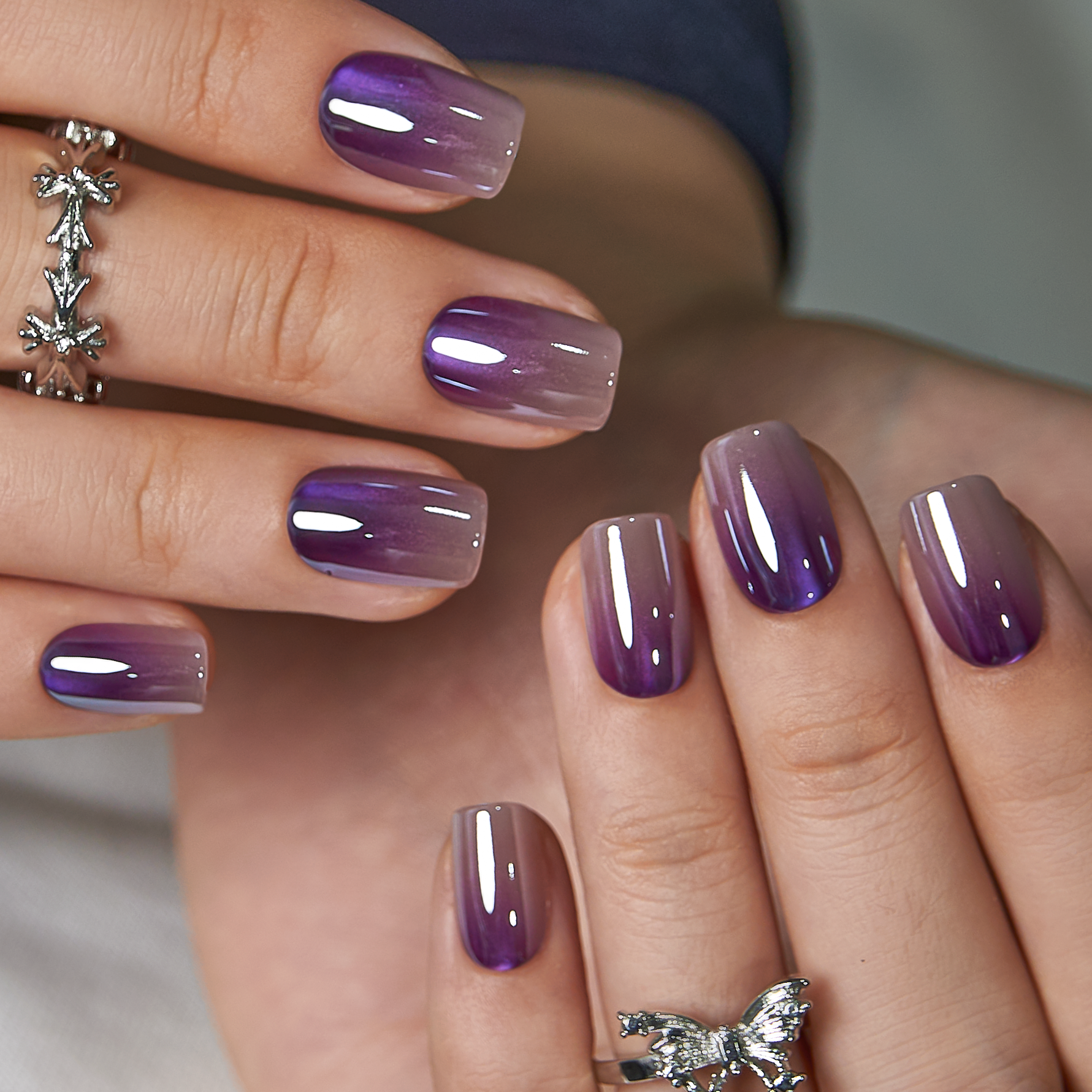 Galaxy Melt short squoval press-on nails worn on a hand