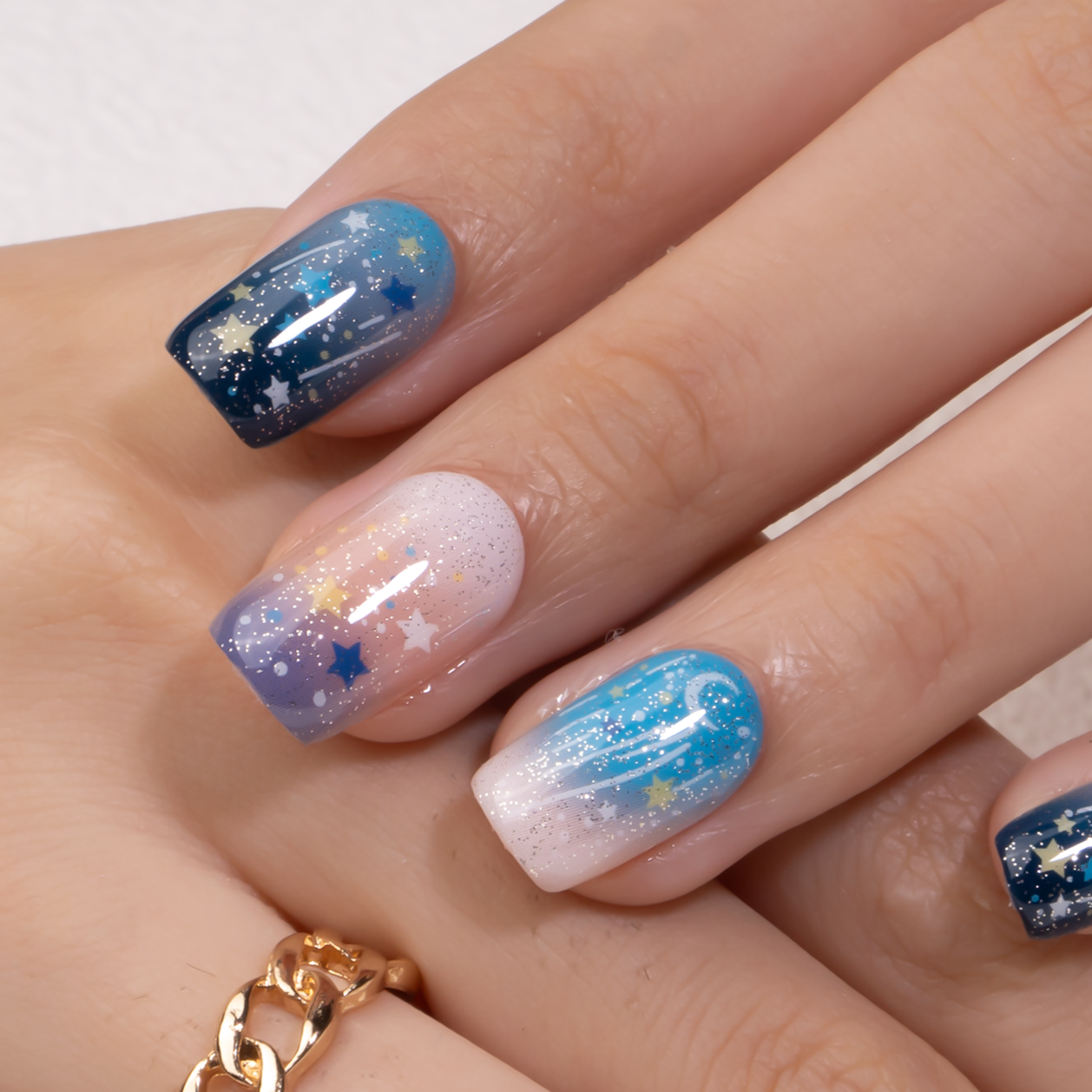 Glistening Star medium squoval press-on nails worn on a hand