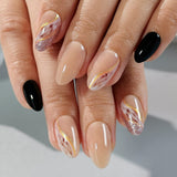 Golden Elegance short almond press-on nails worn on a hand