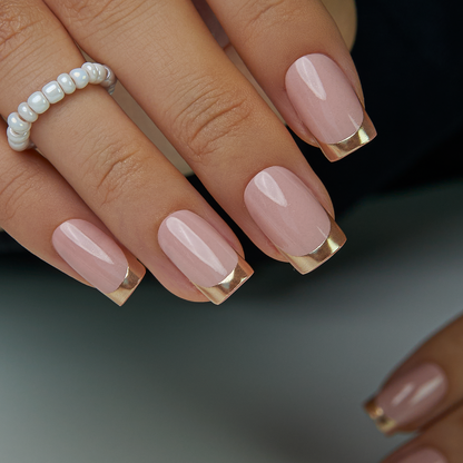 Golden French medium squoval press-on nails worn on a hand