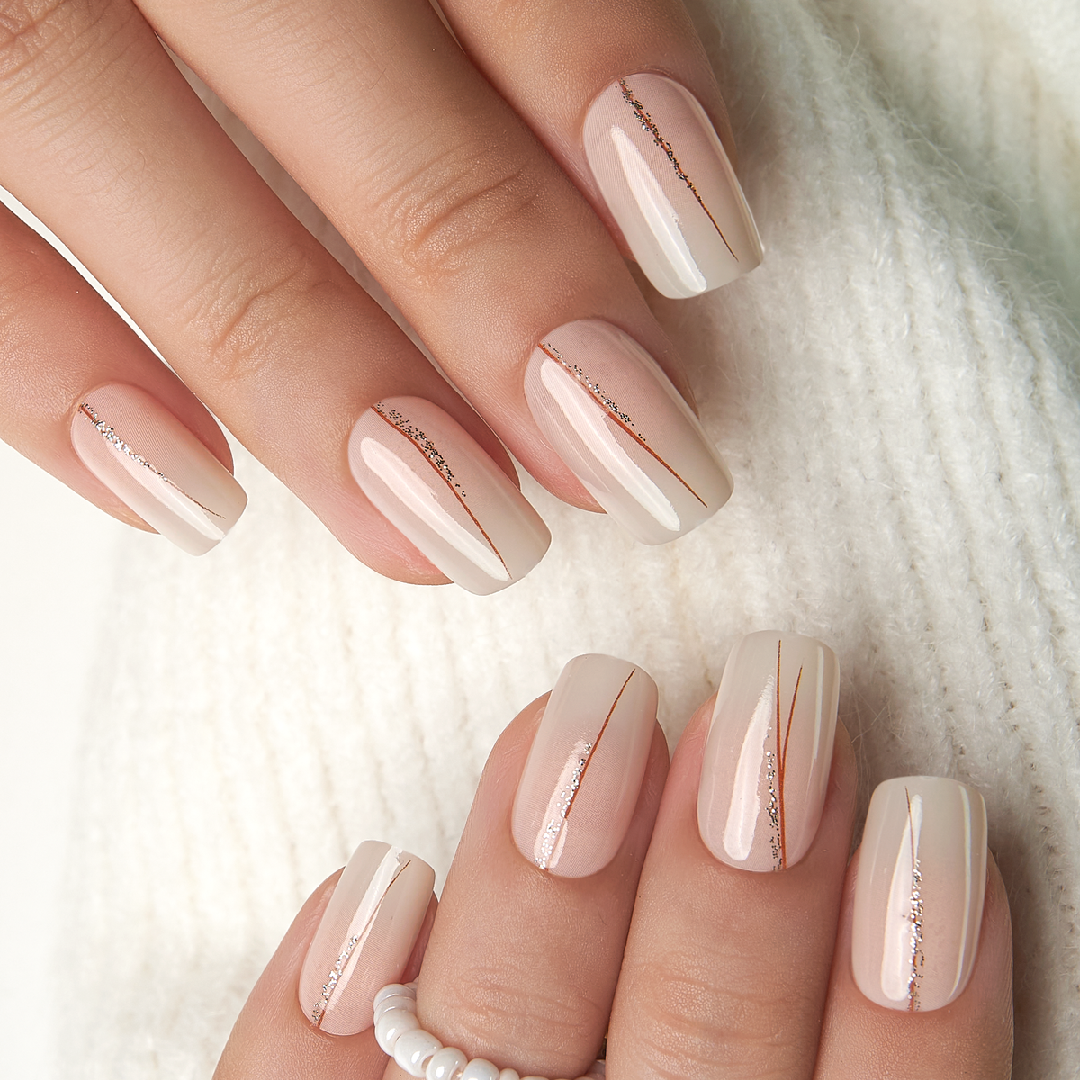 Golden Veil medium squoval press-on nails worn on a hand
