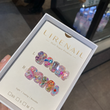 Half-Sugar Promise press-on nails packaging with pink-purple base, colorful gems, heart and fruit charms