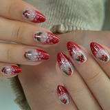 Holly Spark short almond press-on nails worn on a hand