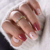 Honey Drift short squoval press-on nails worn on a hand