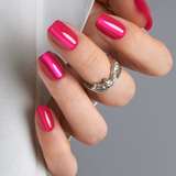 Hot Fuchsia short squoval press-on nails worn on a hand