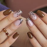 Leopard Temptation medium squoval press-on nails worn on a hand