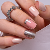 Light Pink Gold short squoval press-on nails worn on a hand