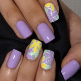 Lilac Floral short squoval press-on nails worn on a hand