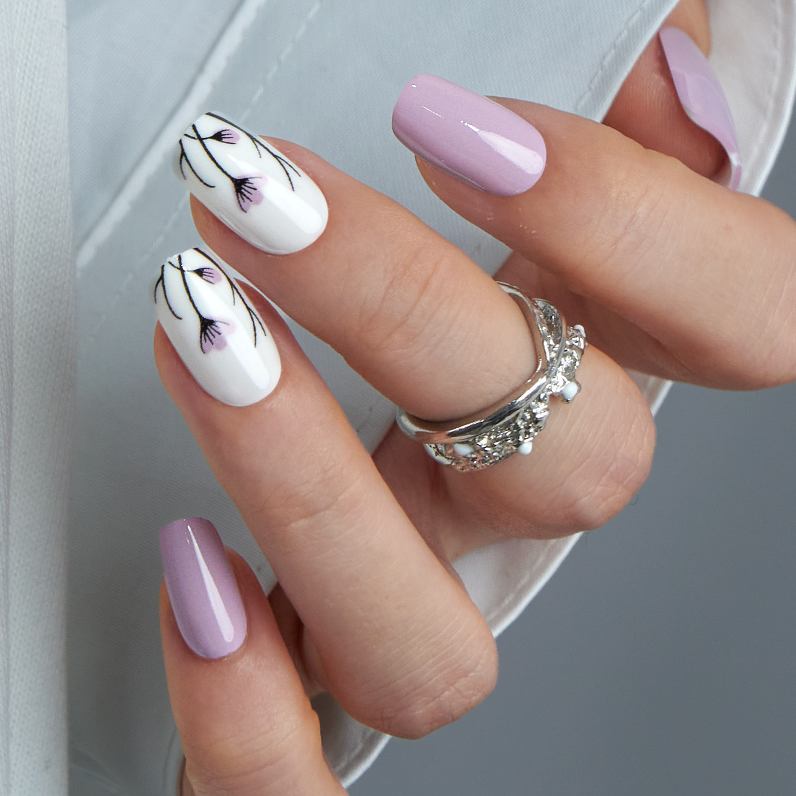 Lilac medium squoval press-on nails worn on a hand
