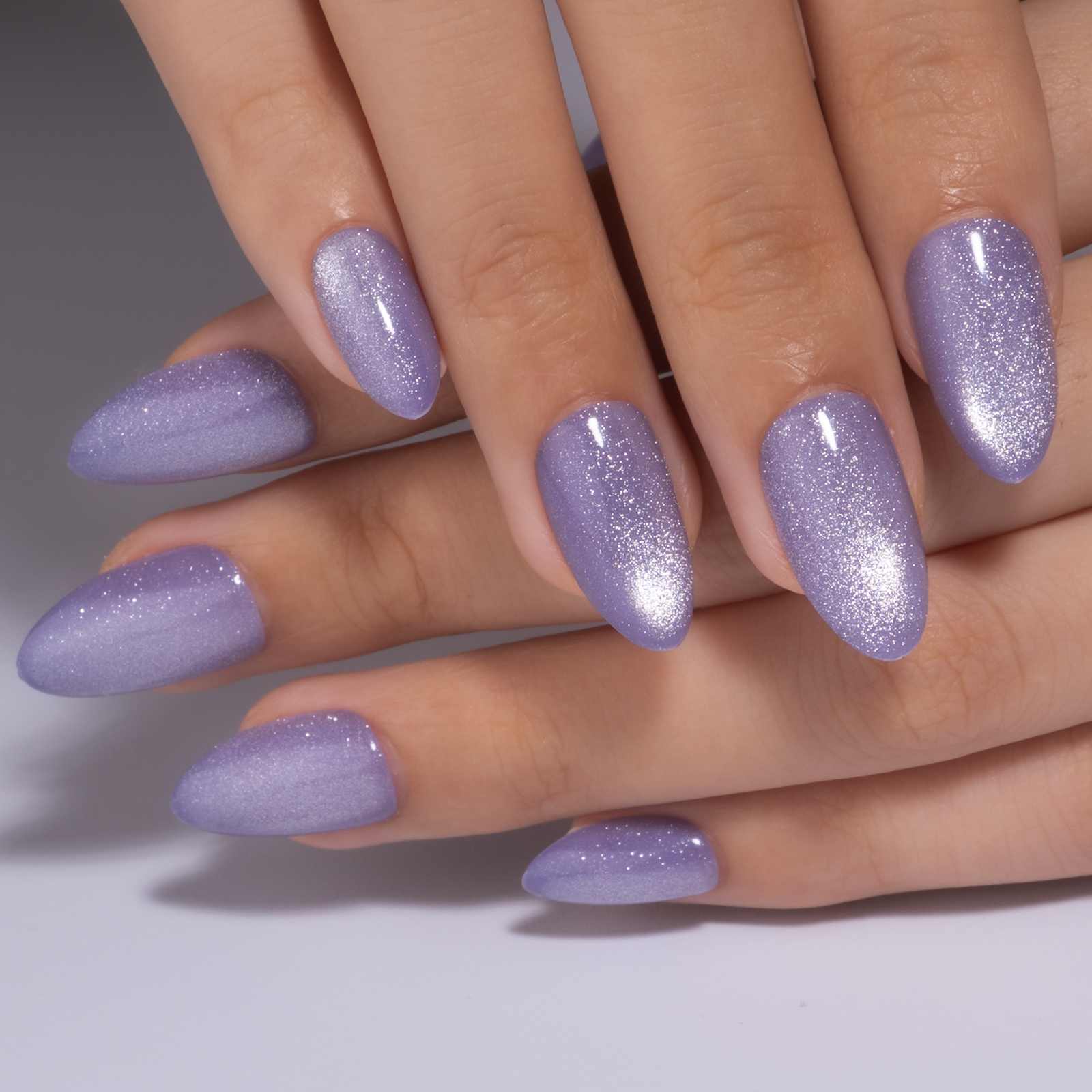 Lilac Shimmer short almond press-on nails worn on a hand