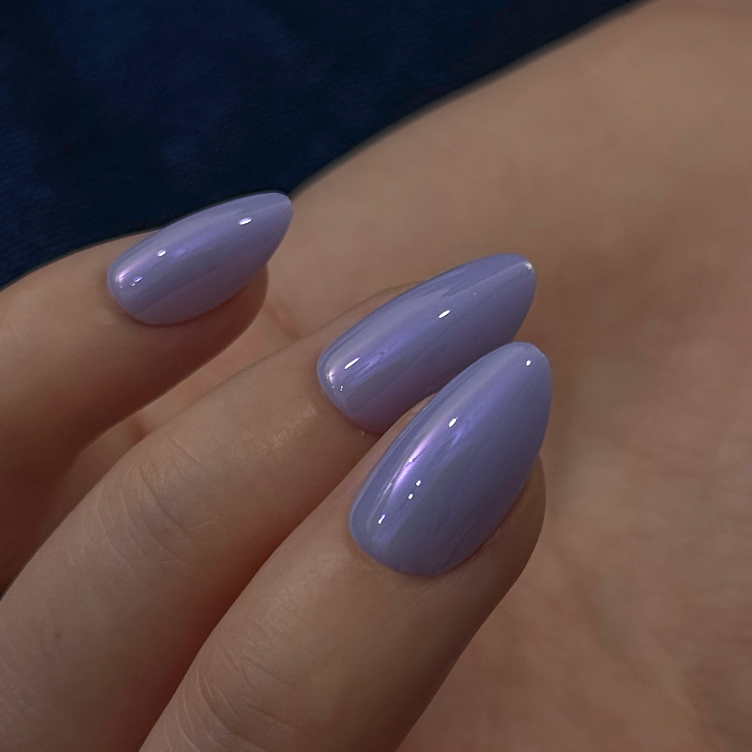 Lilac Shine short almond press-on nails worn on a hand
