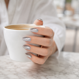 Liquid Silver Cat Eye press-on nails worn on a hand