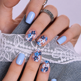 Little Blue short squoval press-on nails worn on a hand