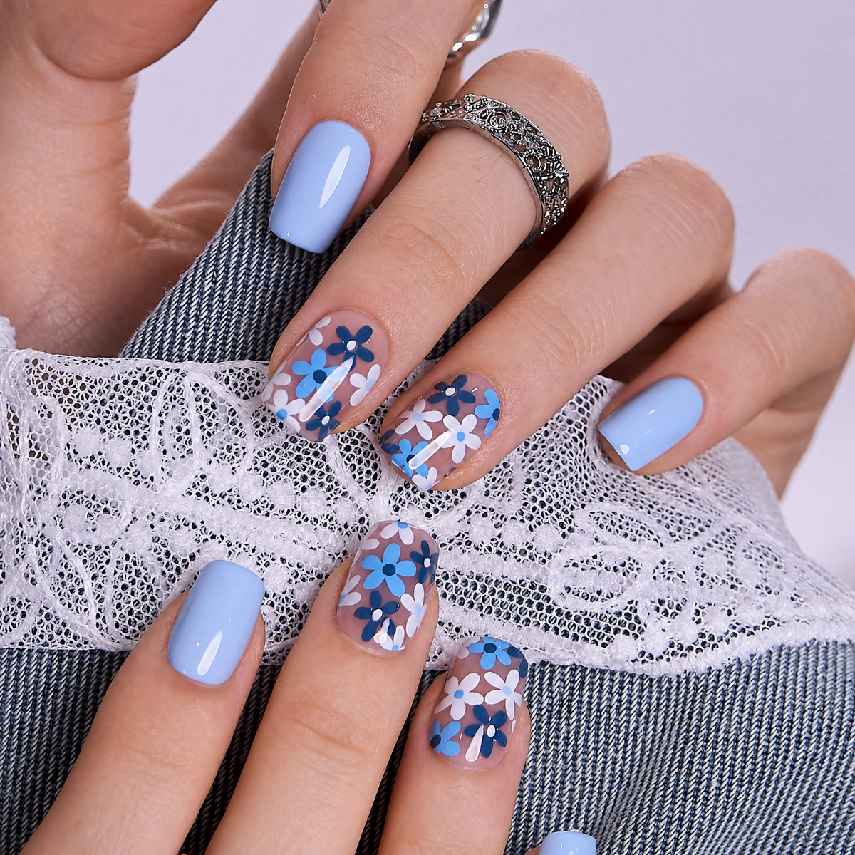 Little Blue short squoval press-on nails worn on a hand