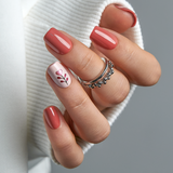 Love Blossom short squoval press-on nails worn on a hand