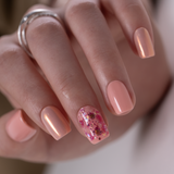 Lovely Pearl short squoval press-on nails worn on a hand