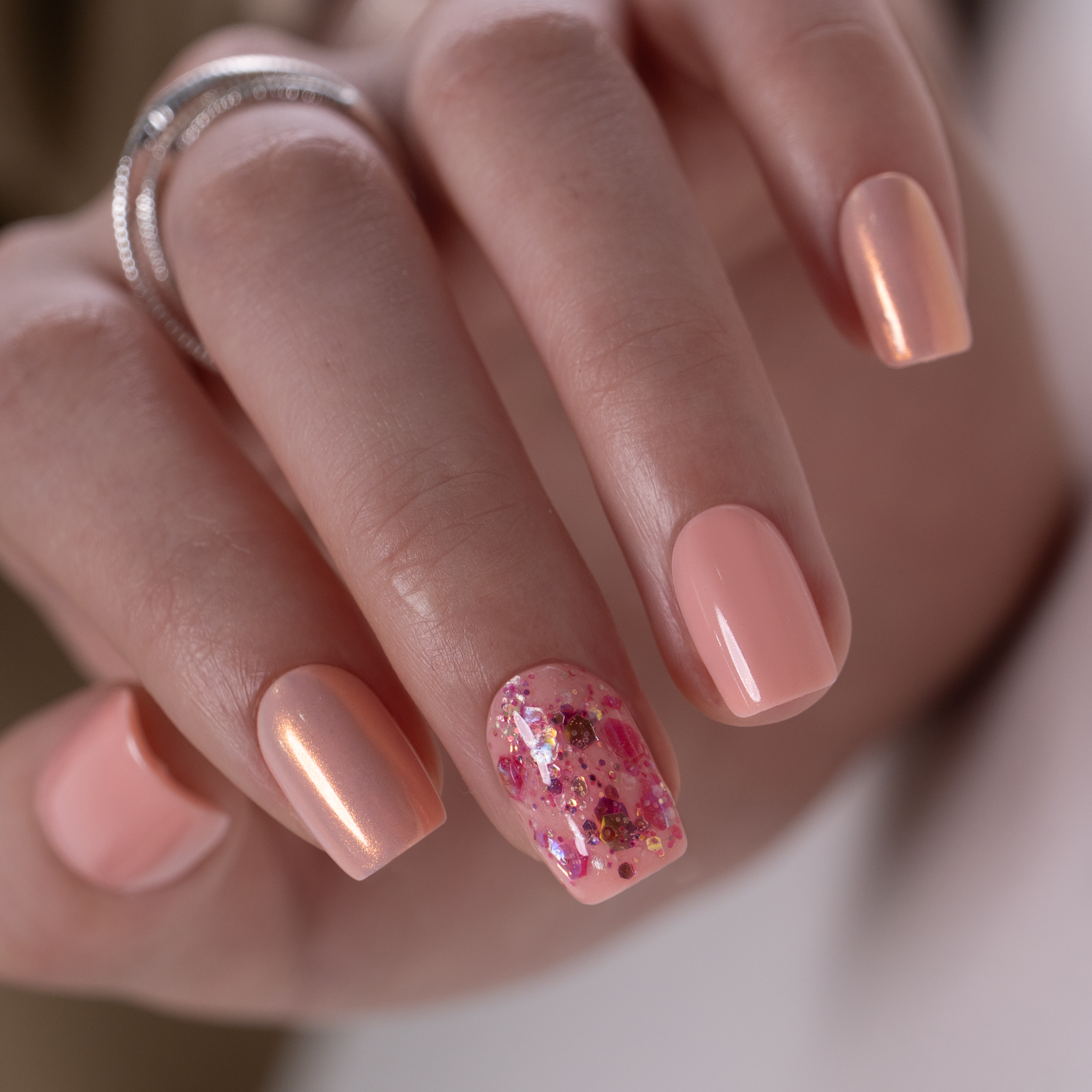 Lovely Pearl short squoval press-on nails worn on a hand
