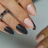 Matte Night short almond press-on nails worn on a hand