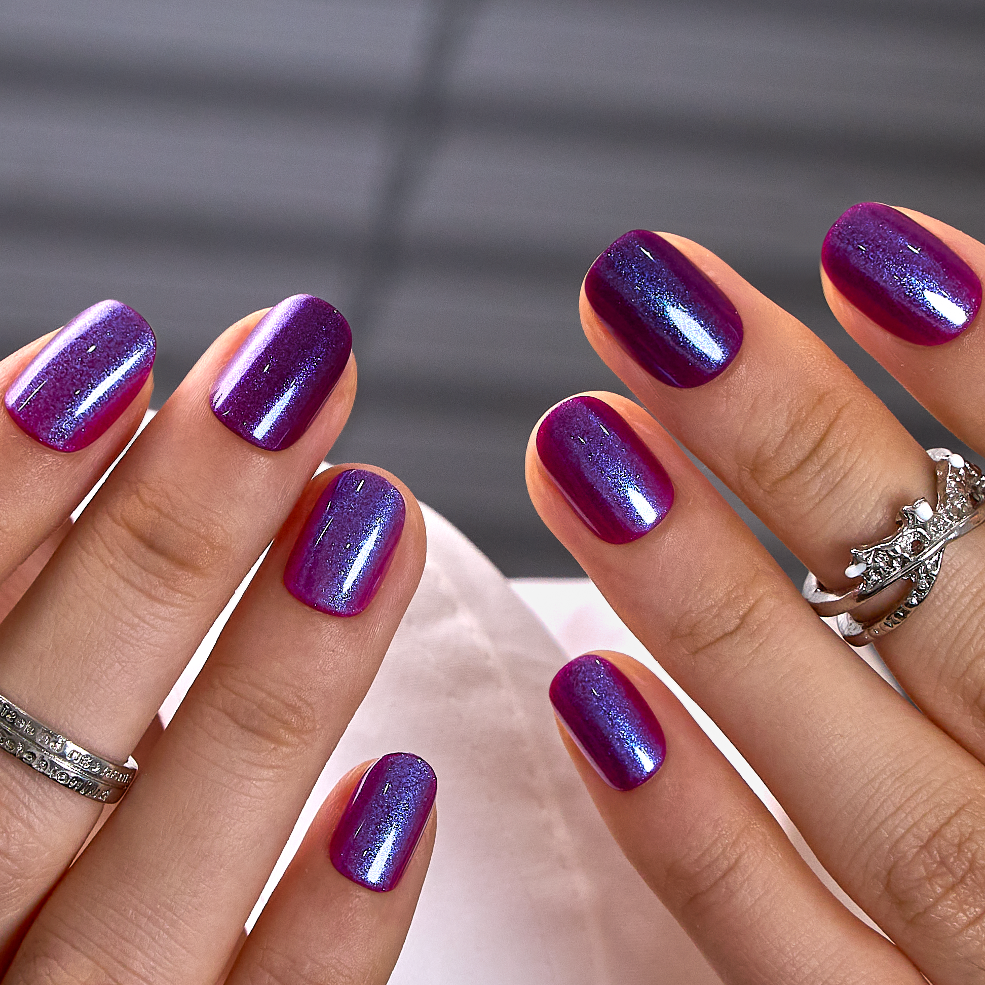 Midnight Amethyst Rs squoval press-on nails worn on a hand