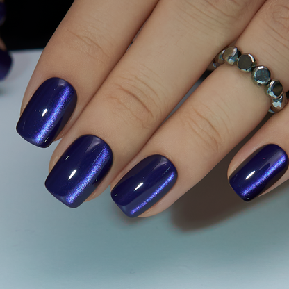 Midnight Aura short squoval press-on nails worn on a hand