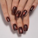 Midnight Spark short squoval press-on nails worn on a hand
