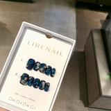 Lirenail press-on nails packaging with dark blue base, blue gem and silver star accents