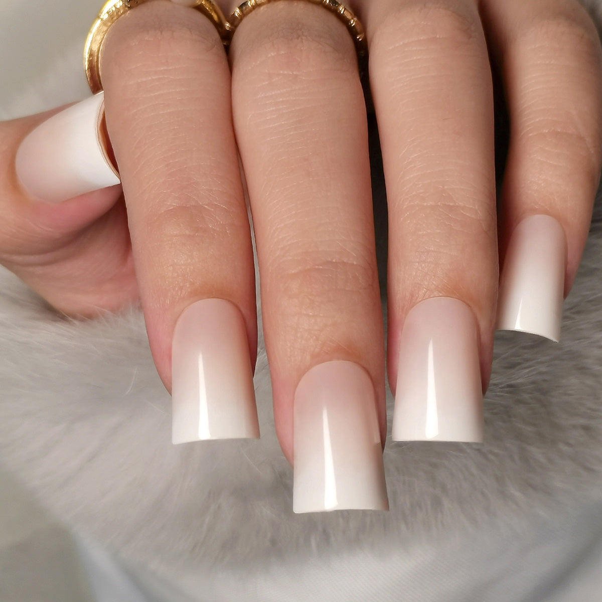 Milky Dream Fade M Duckbill press-on nails worn on a hand