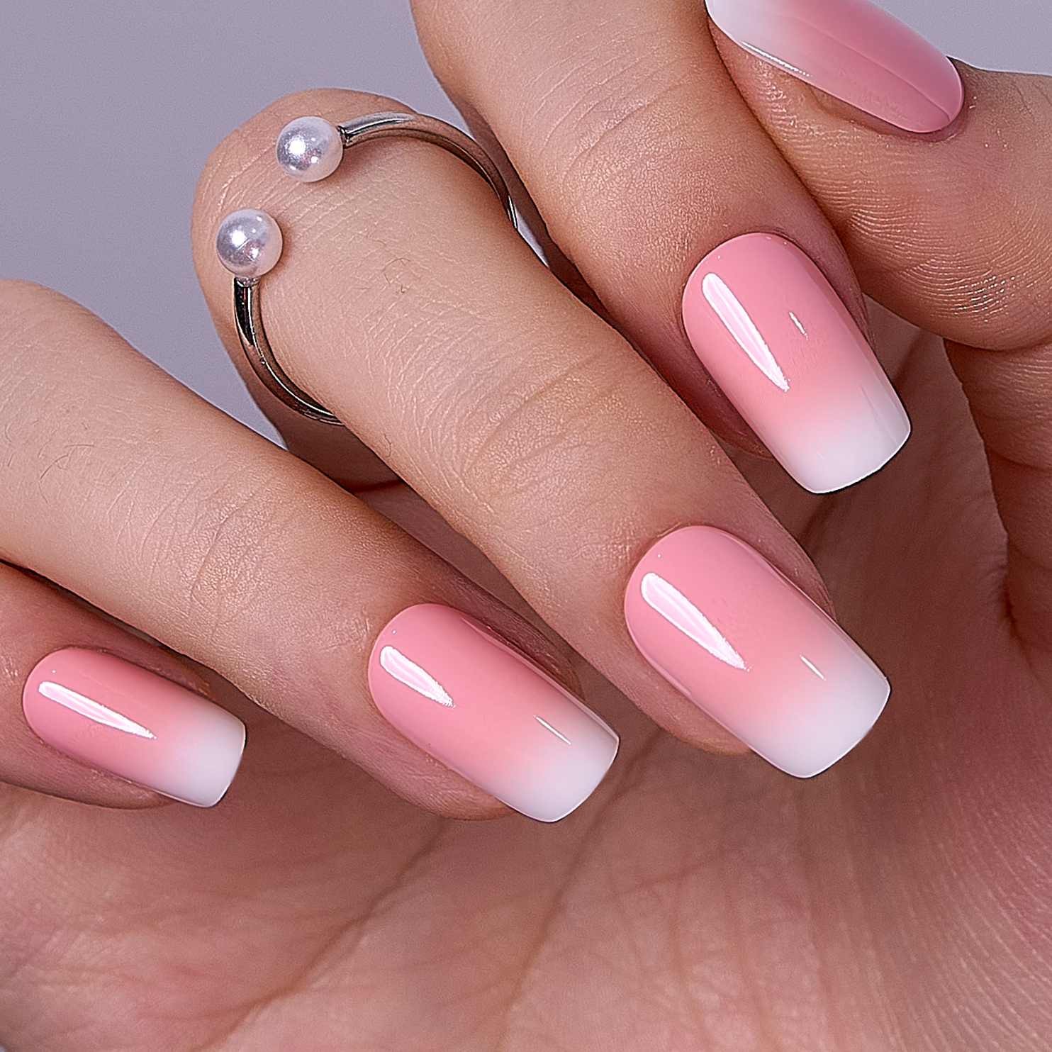 Milky Petal Glow short squoval press-on nails worn on a hand