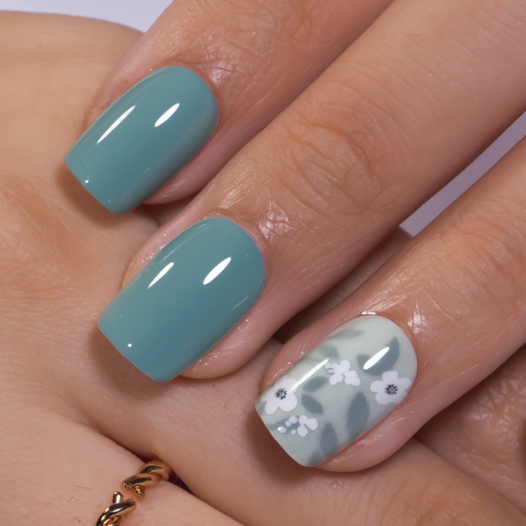 Minty Floral short squoval press-on nails worn on a hand