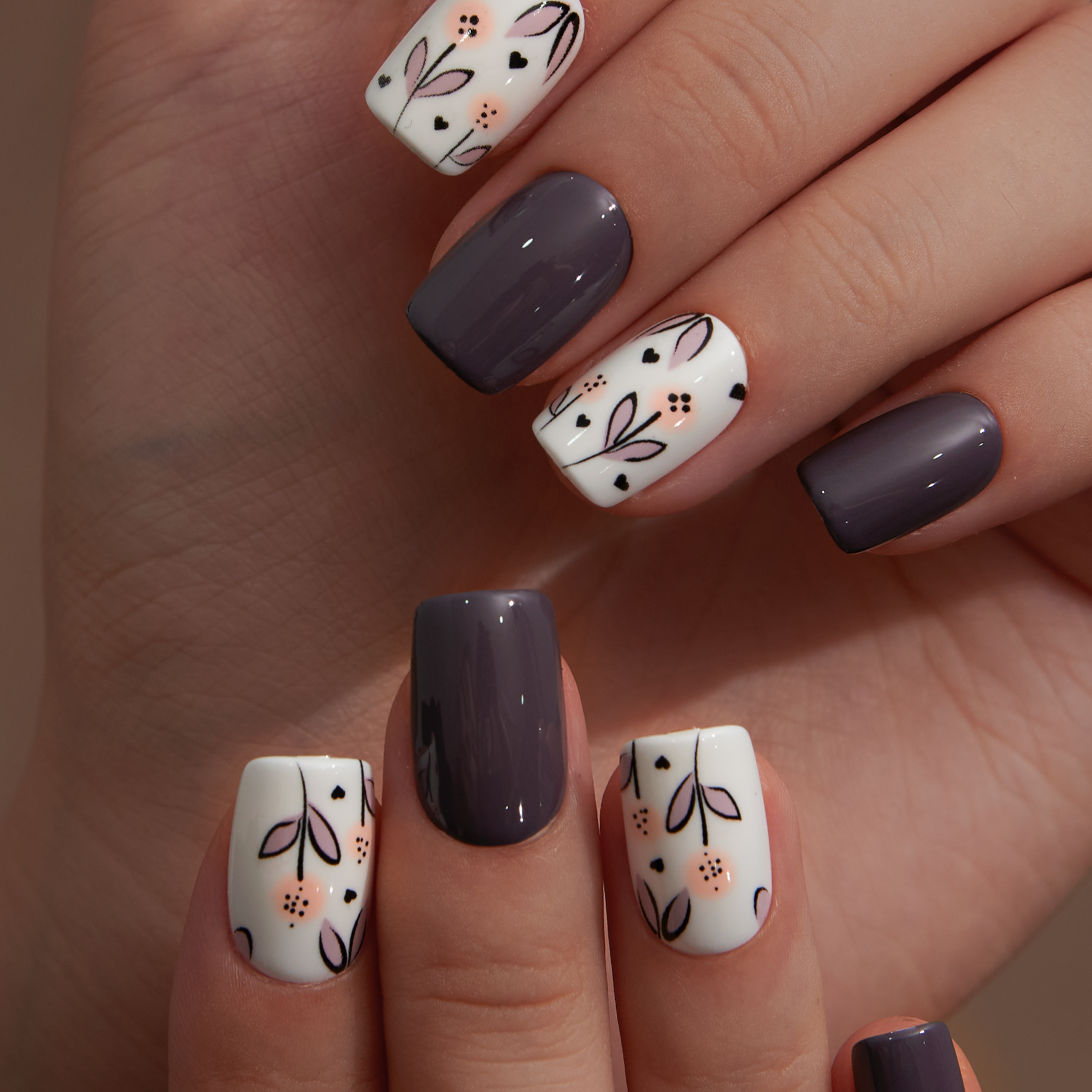 Mocha Bloom short squoval press-on nails worn on a hand