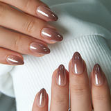 Mocha Chrome short almond press-on nails worn on a hand