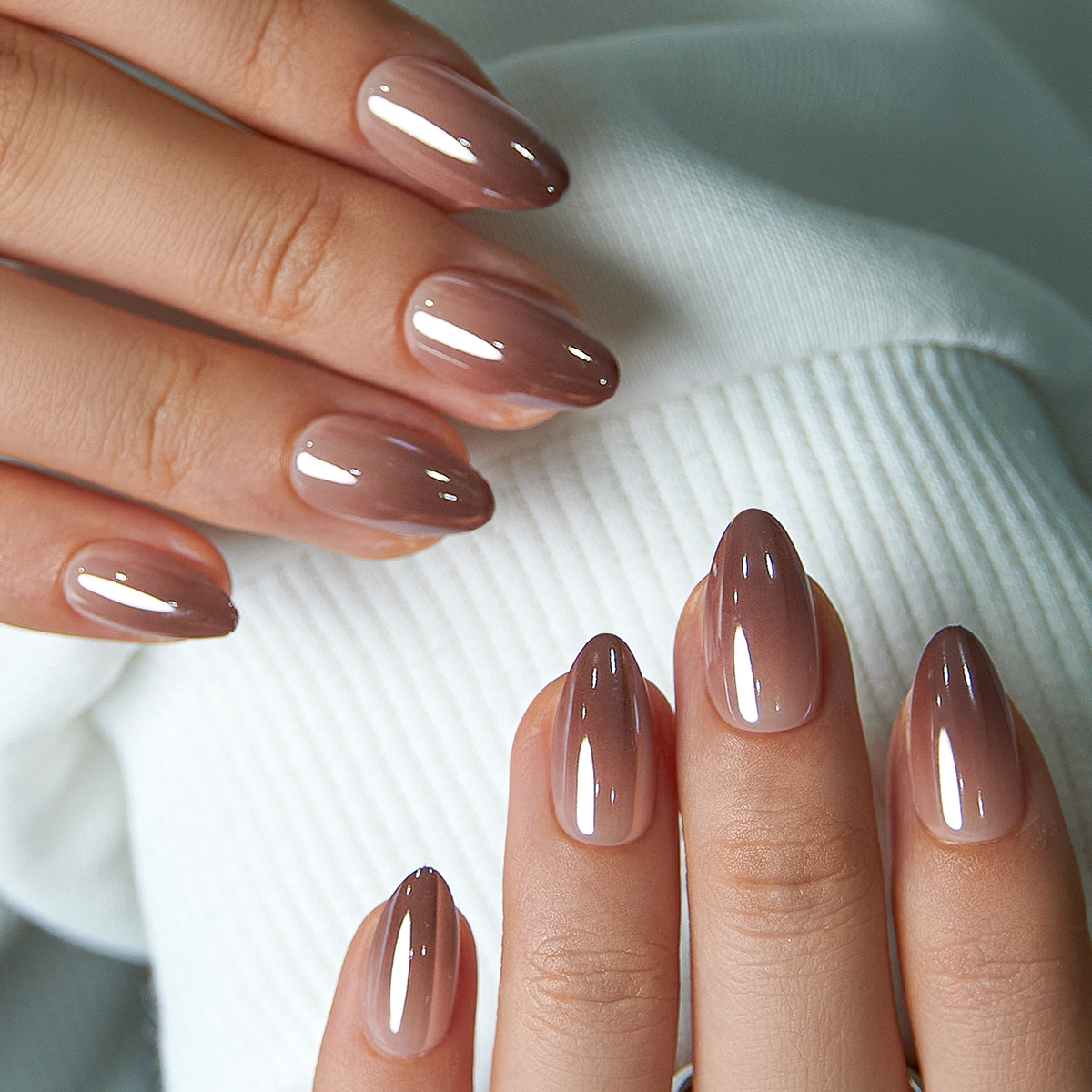 Mocha Chrome short almond press-on nails worn on a hand
