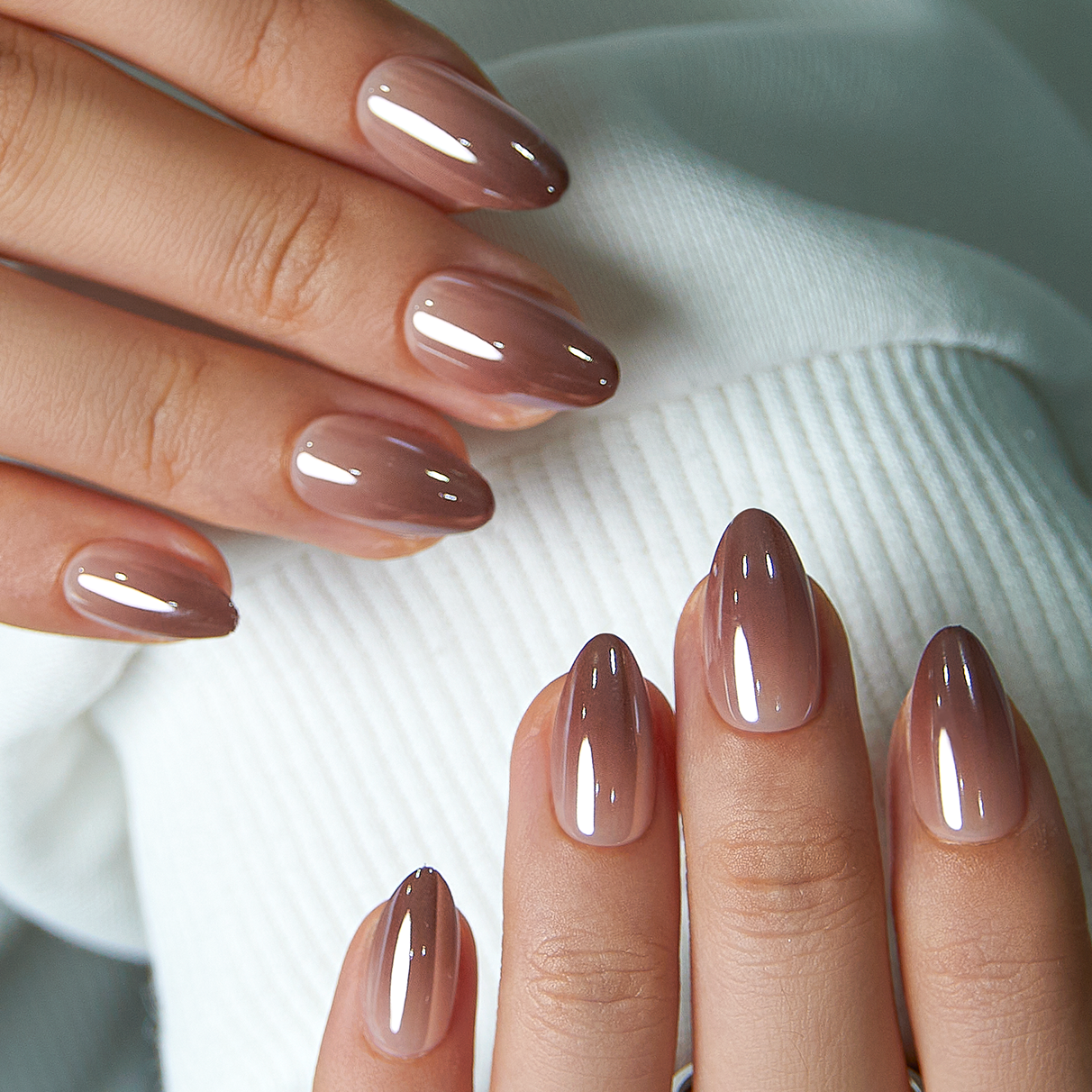 Mocha Chrome short almond press-on nails worn on a hand