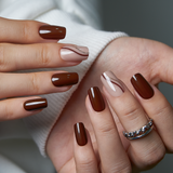 Mocha Line Dream medium squoval press-on nails worn on a hand