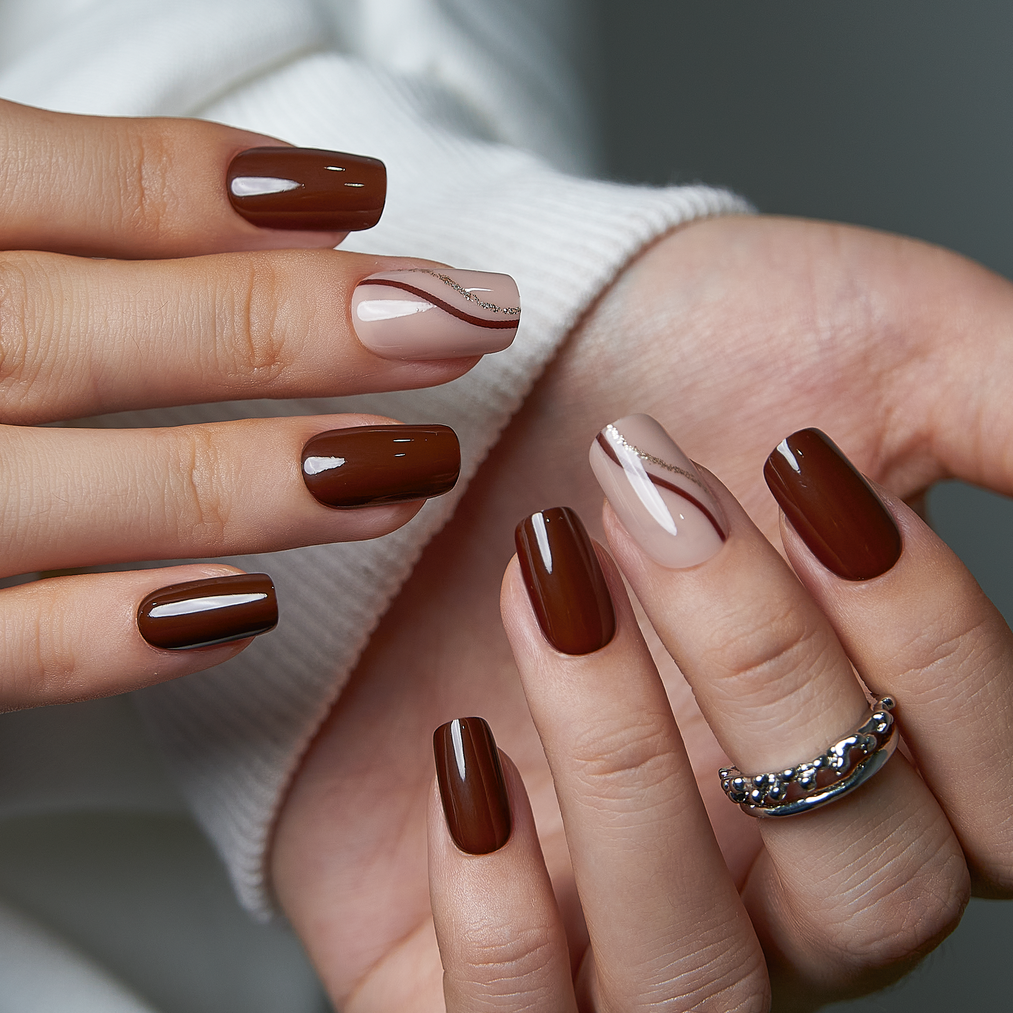 Mocha Line Dream medium squoval press-on nails worn on a hand