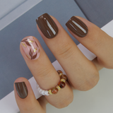 Mocha Luxe short squoval Ver 2 press-on nails worn on a hand