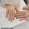 Moonlit Galaxy silver press-on nails worn on a hand