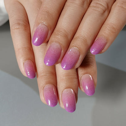 Moonlit Lilac short oval press-on nails worn on a hand