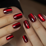 Mysterious Crimson short squoval press-on nails worn on a hand