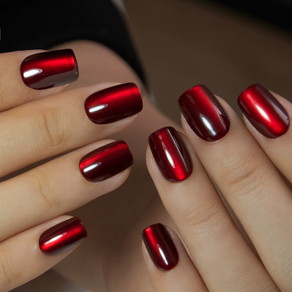 Mysterious Crimson short squoval press-on nails worn on a hand