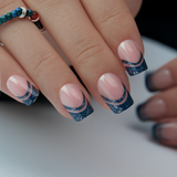 Mysterious Purple short squoval press-on nails worn on a hand