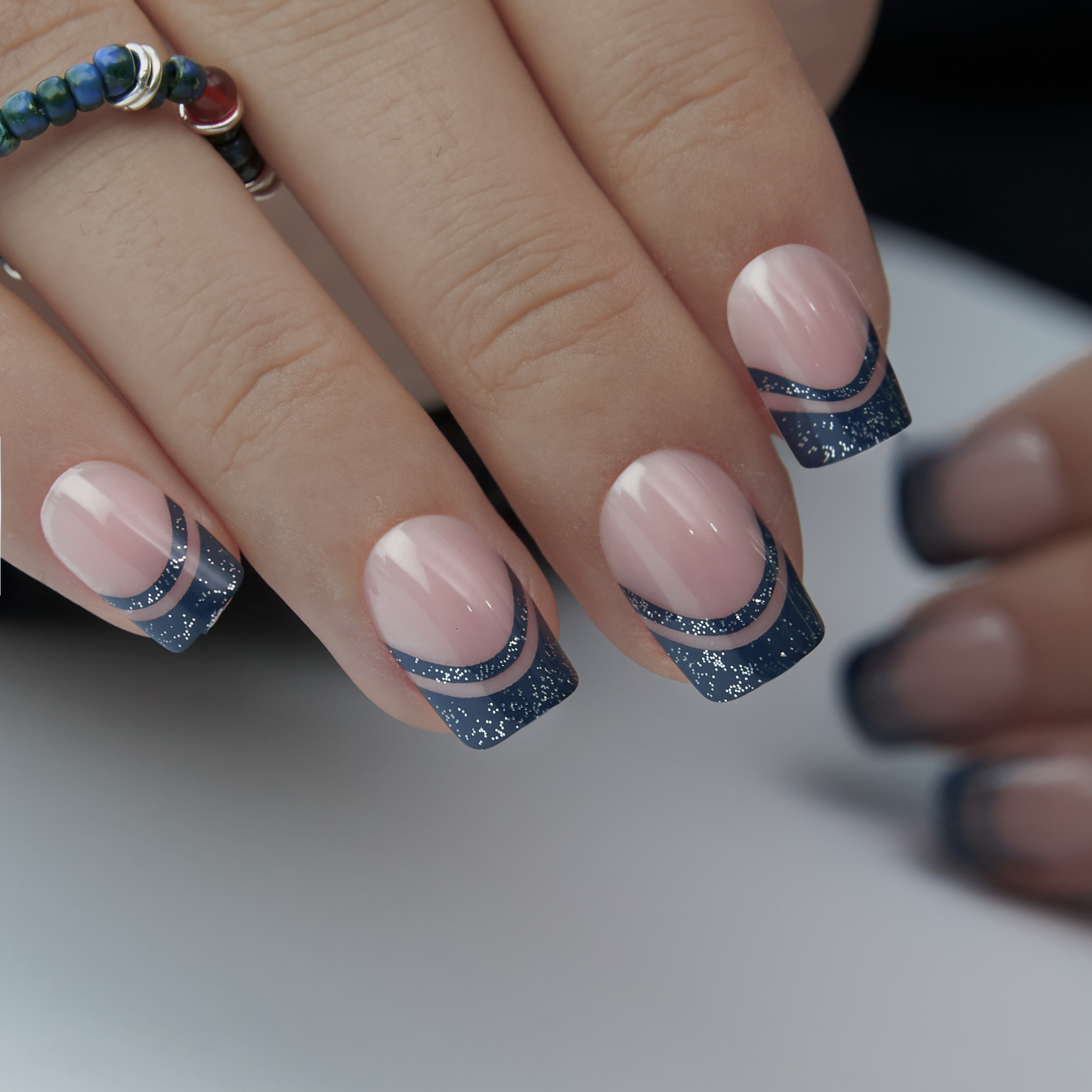 Mysterious Purple short squoval press-on nails worn on a hand