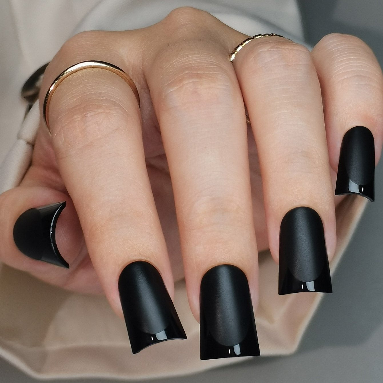 Noir Edge Glow M Duckbill press-on nails worn on a hand