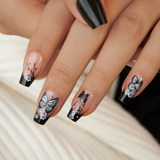Noir Papillon M Coffin press-on nails worn on a hand
