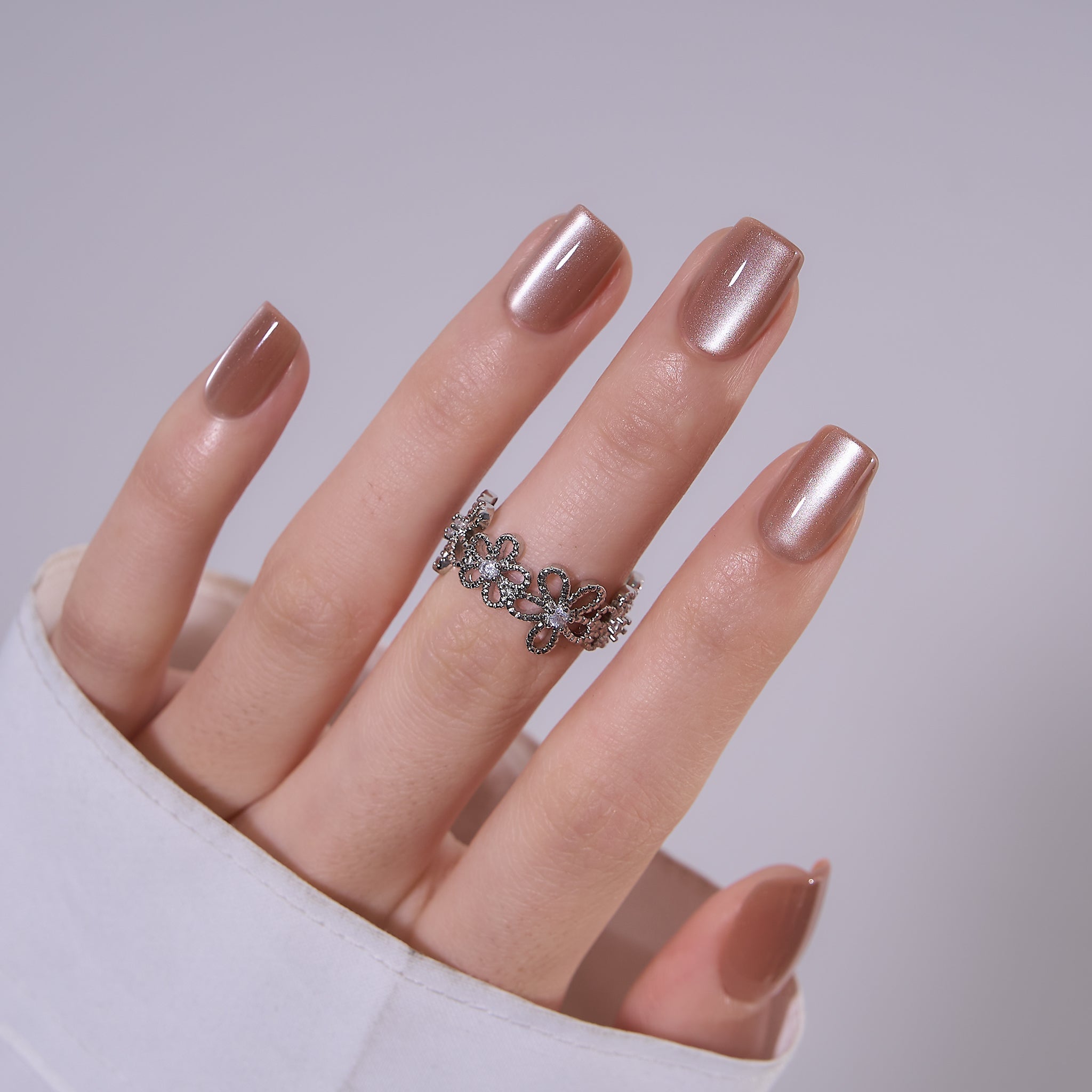 Nude Cat Grace medium squoval press-on nails worn on a hand